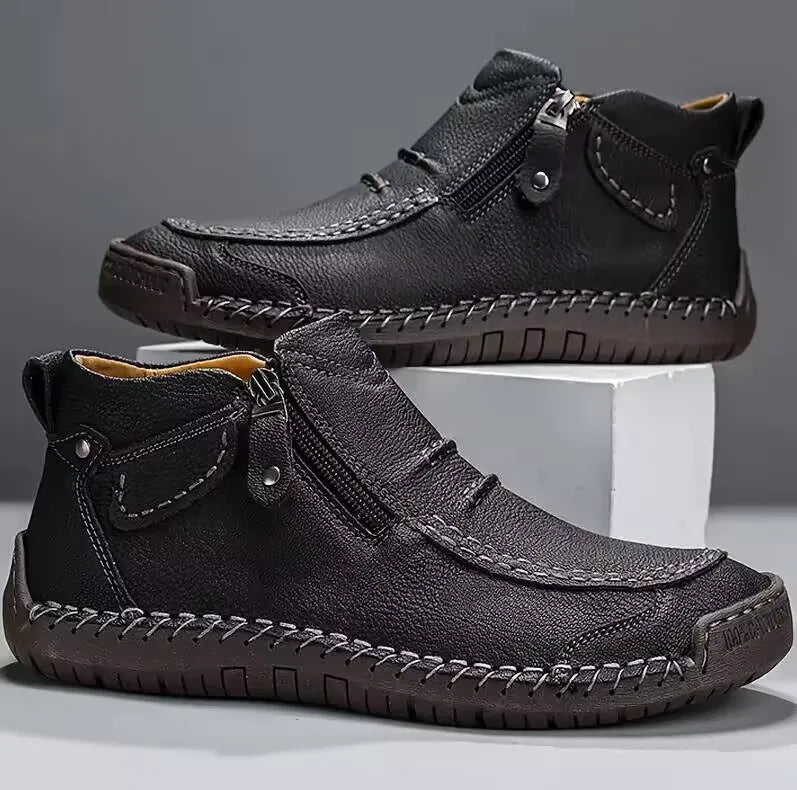Men's brown premium leather boots with hand-stitched detailing, cushioned sole, and side zip closure