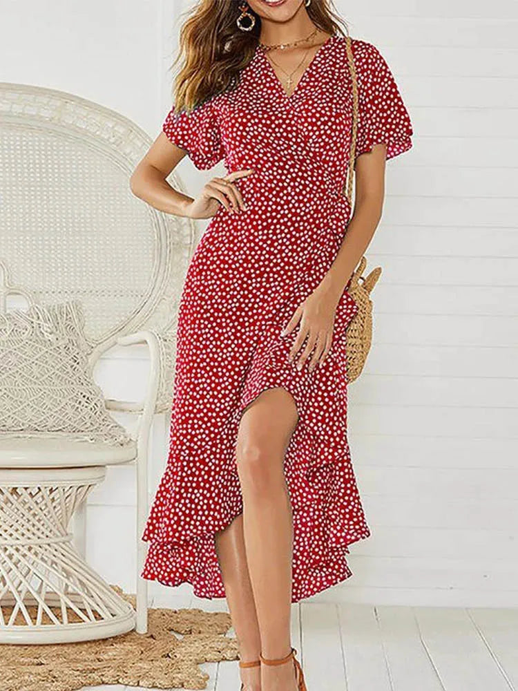White polka dot maxi dress flutter sleeves V-neckline ruffled hem breezy vacation silhouette