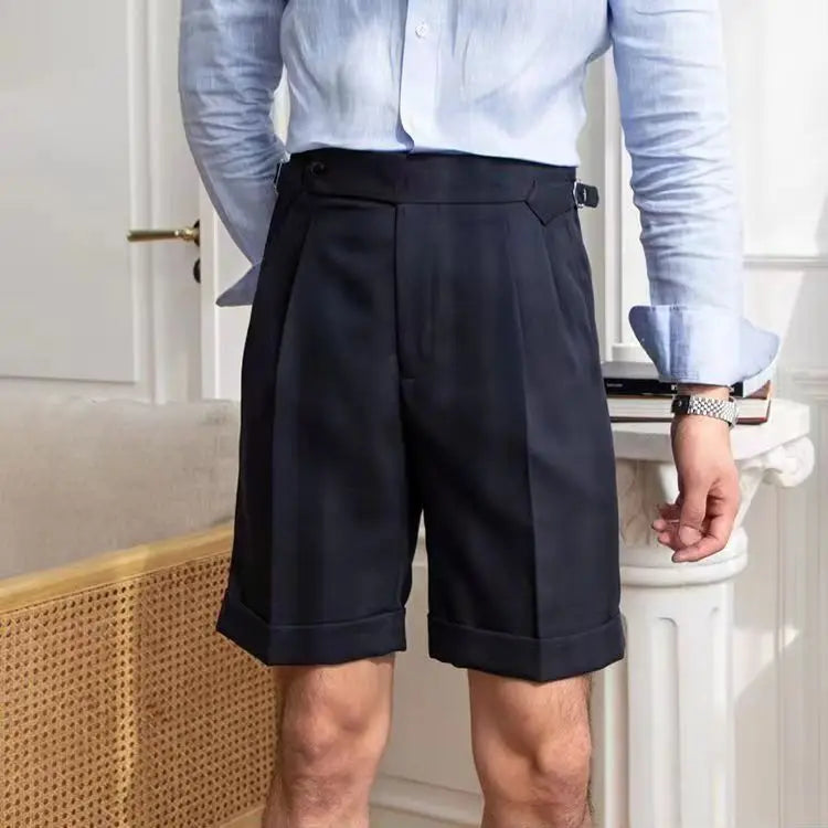Men's cotton knee-length dress shorts with pleated front, cuffed hem, and slim tailored fit