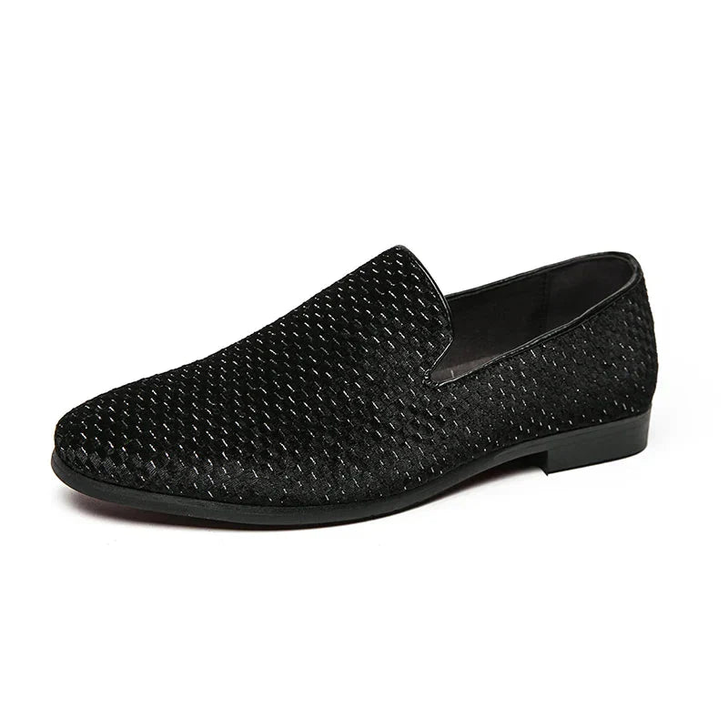 Men's black slip-on loafers with embossed geometric pattern, sleek silhouette for modern formal style