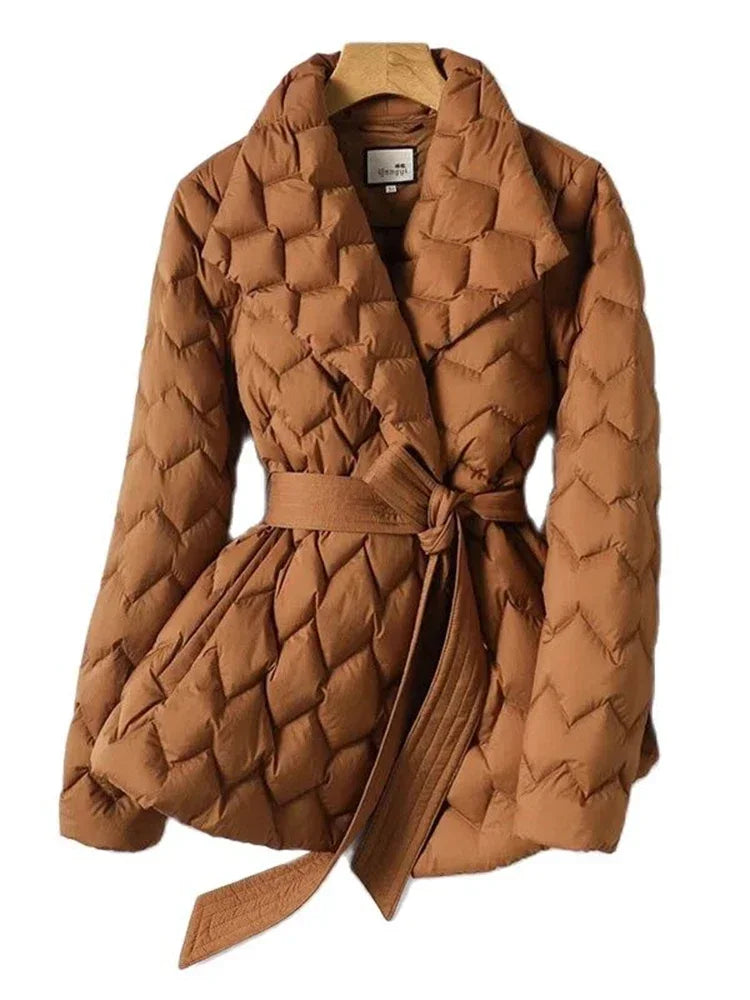 Women's white quilted puffer coat with waist-cinching belt, premium duck down insulated elegant fit