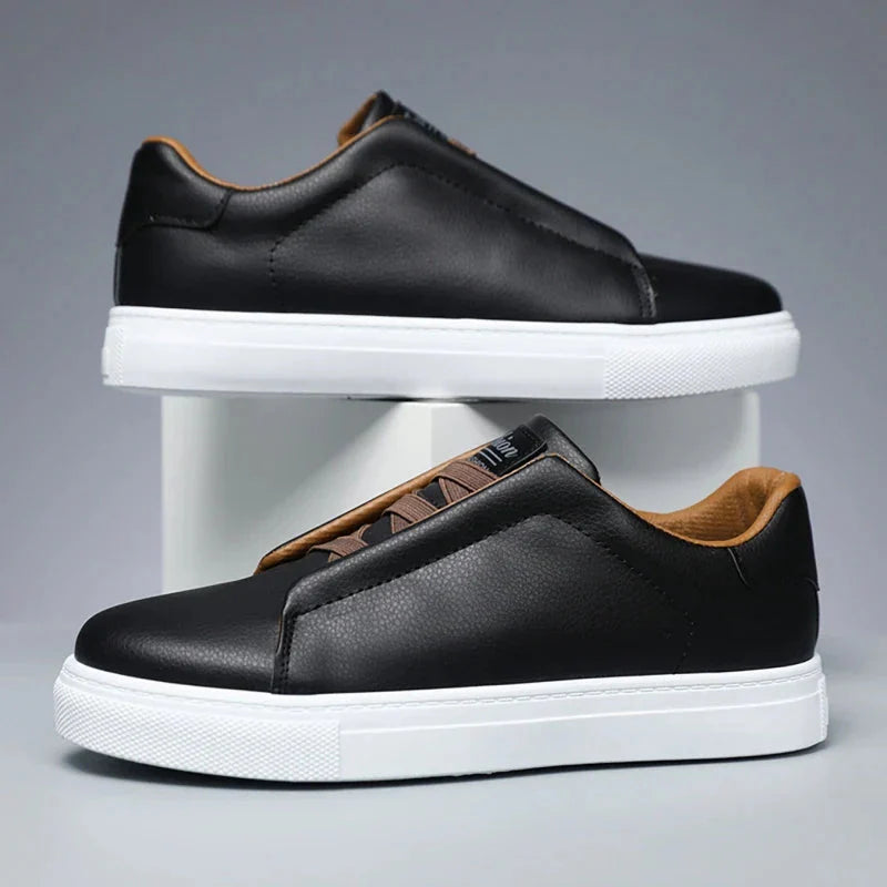 Men's white leather slip-on low-top sneakers with laceless design and branded tongue detail