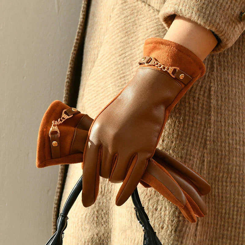 Women's black leather wrist-length gloves with gold chain accent detail for sophisticated style