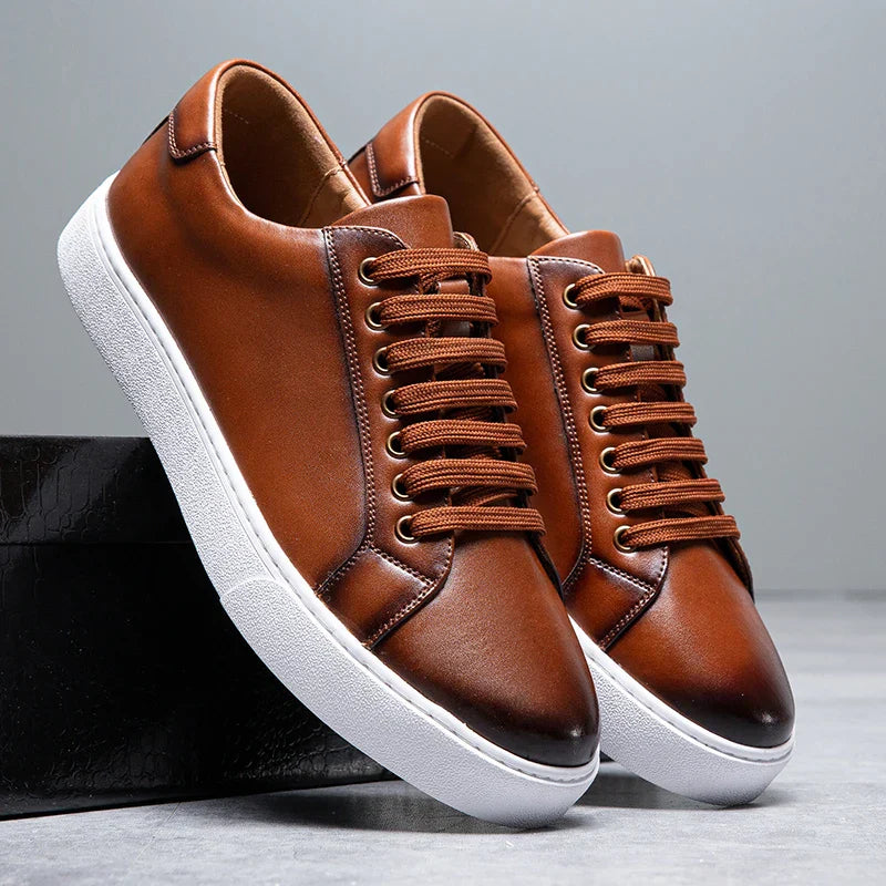 White minimalist genuine leather unisex sneakers with cushioned sole and clean low-top silhouette
