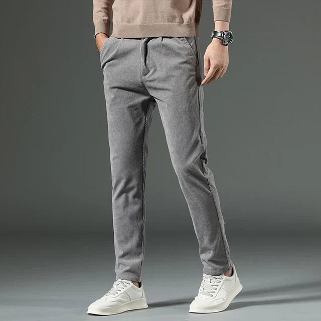 Men's relaxed pleated-front trousers with ribbed side pockets in neutral tones for casual fall comfort
