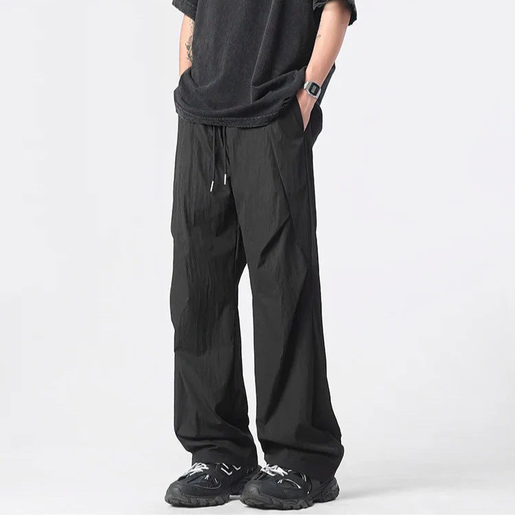 Tufted nylon parachute pants wide-leg silhouette crinkled texture neutral streetwear lightweight breathable