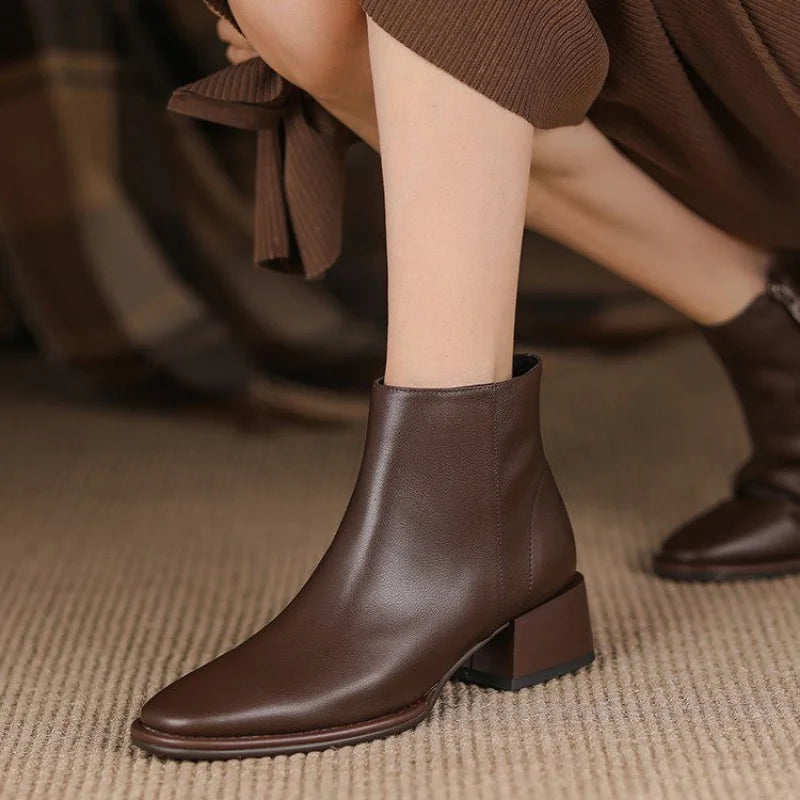 Women's black chunky heel ankle boots with pointed toe and side zipper closure for office wear