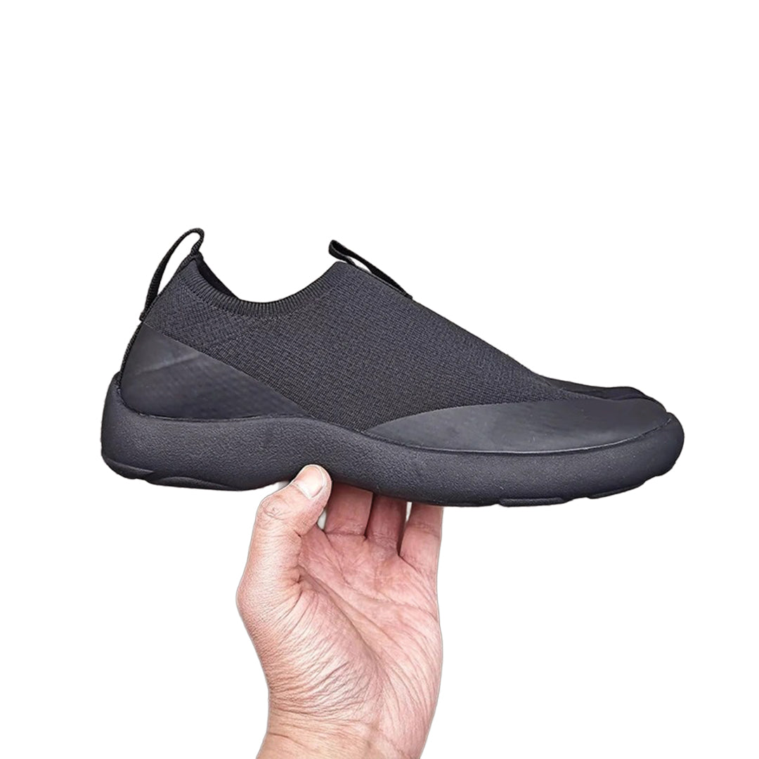 Black minimalist tabi slip-on sneakers with bold split-toe silhouette for modern casual wear