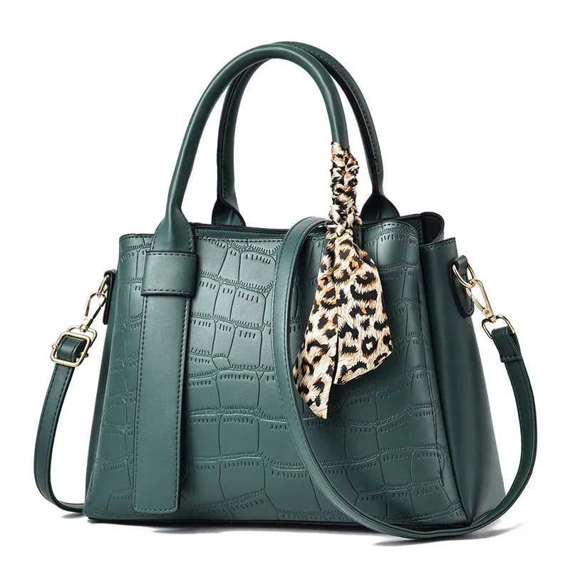 Structured women's black embossed leather tote bag with elegant texture and versatile top handles