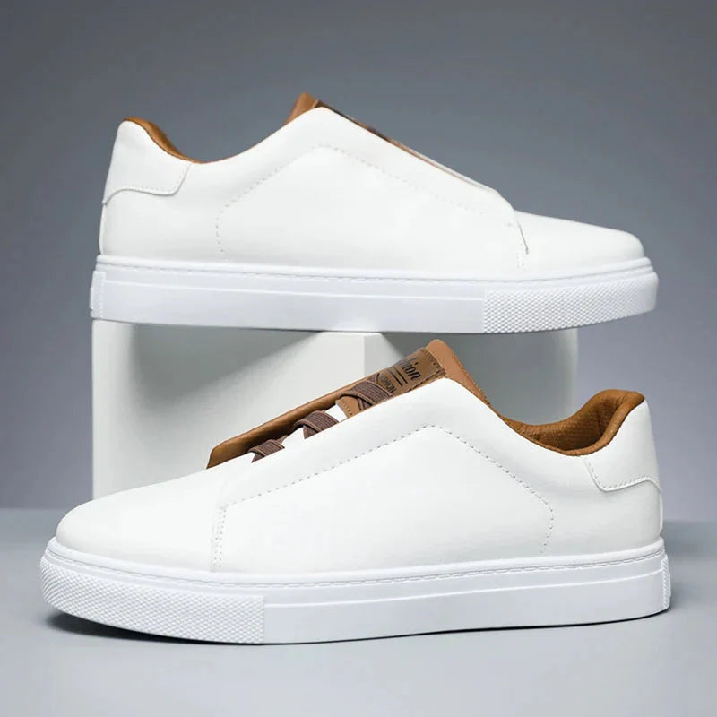 Men's white leather slip-on low-top sneakers with laceless design and branded tongue