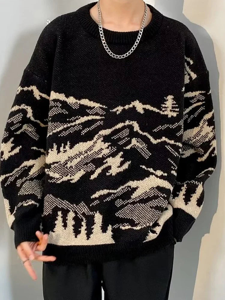 Oversized cream knit sweater with detailed mountain landscape pattern, soft rugged outdoor style