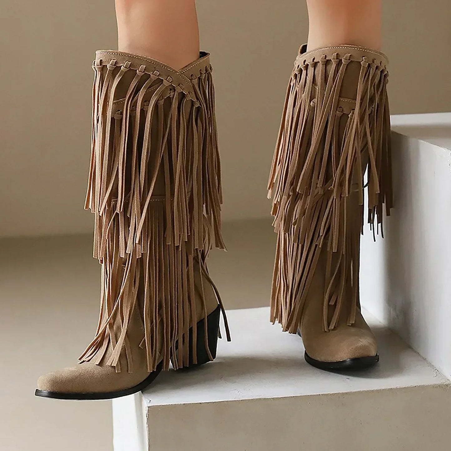 Women's western knee-high boots with long flowing fringe detailing and sturdy block heel