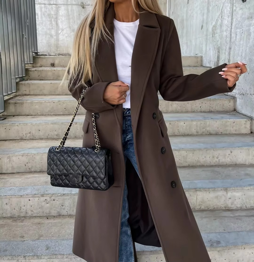 Women's long winter trench coat in neutral tone, structured notched collar, button placket, cold-weather