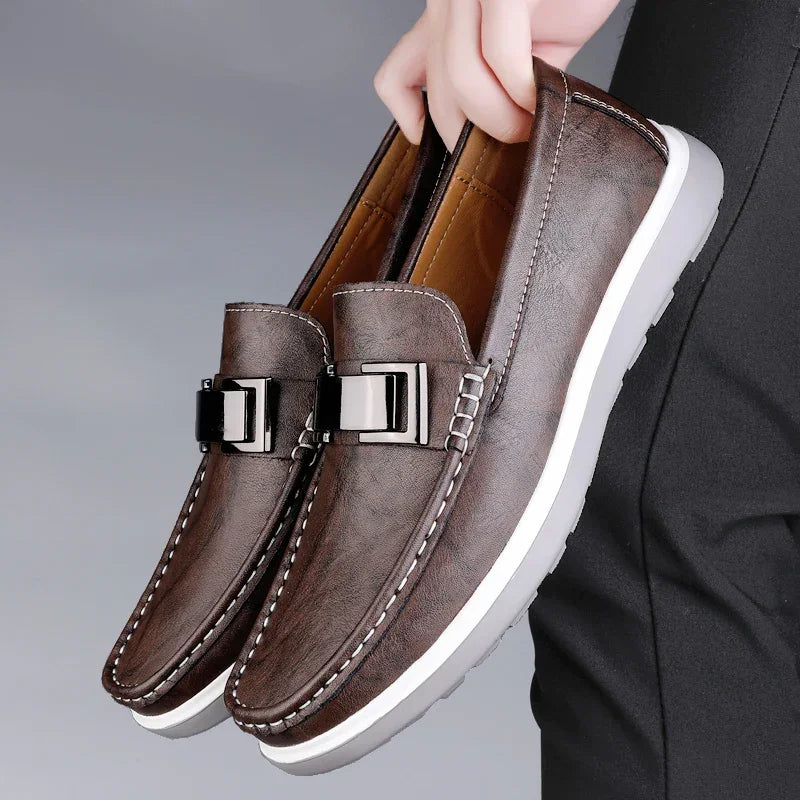 Brown textured leather loafers with gloss buckle detail and contrast stitching for city professionals