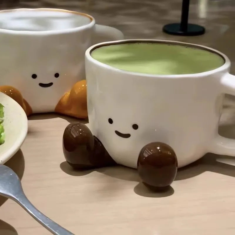 TrendAura hand-glazed ceramic mug with smiley face design, velvety finish, and playful leg charm for cozy mornings