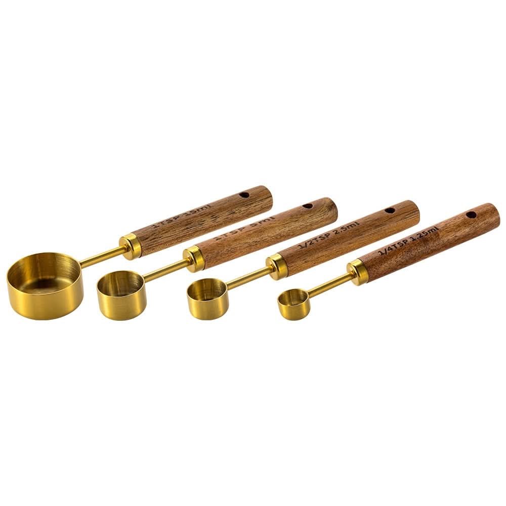 Gold-toned metal measuring cup set with wood handles, engraved markings, elegant kitchen tool