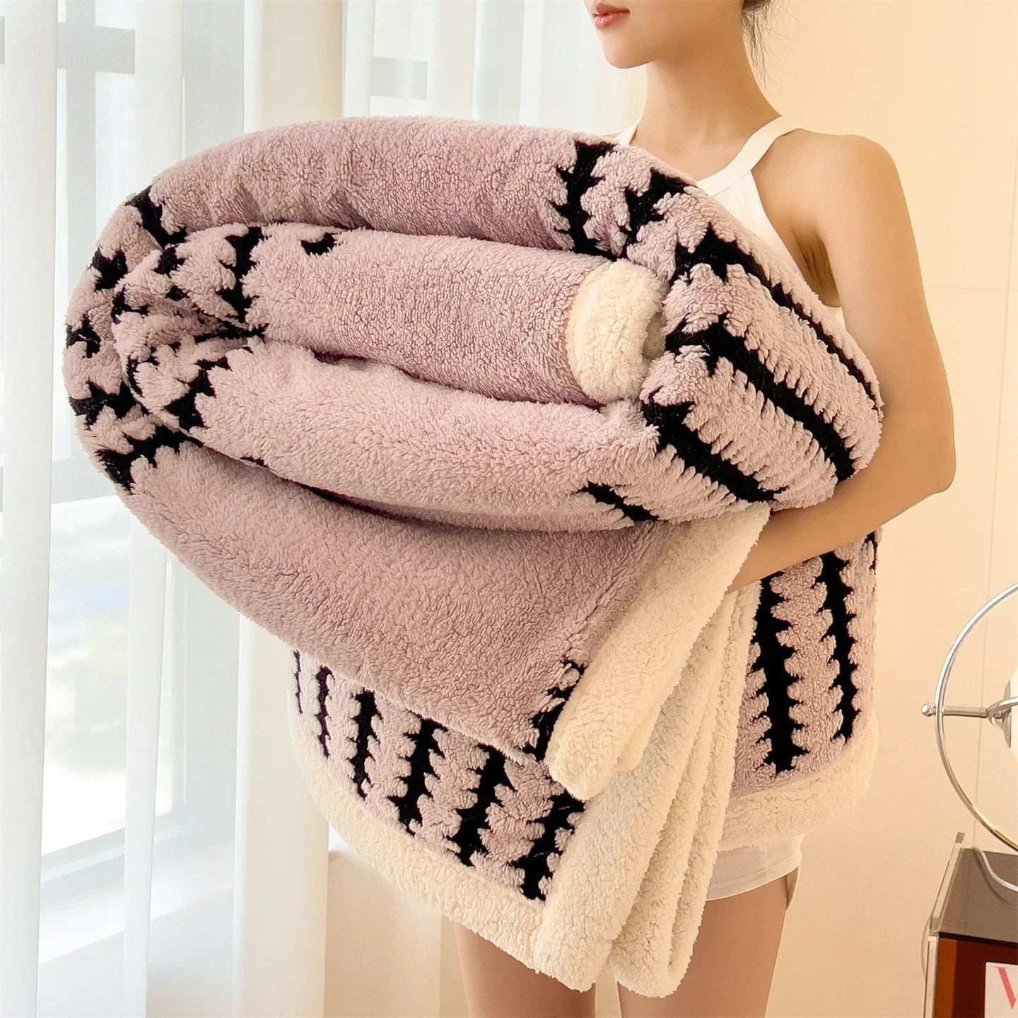 Dual-sided sherpa flannel throw blanket, smooth patterned side and plush white fleece reverse for cozy lounging