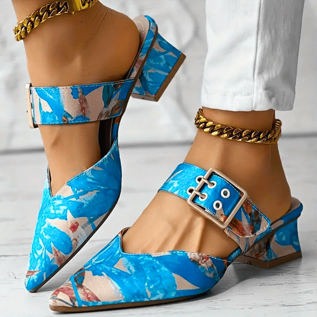 Women's beige closed-toe block heel mules with gold buckle strap, polished slip-on style