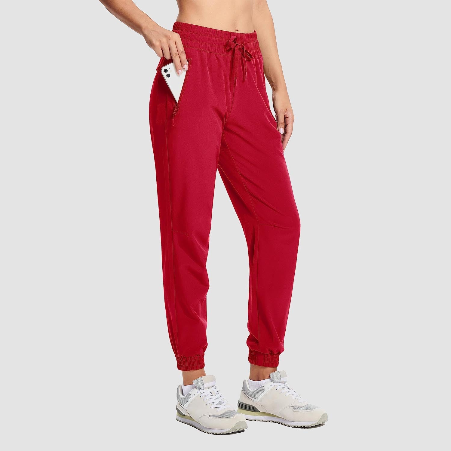 Women's lightweight gray hiking joggers with 4-way stretch, water-resistant fabric, and secure side pockets
