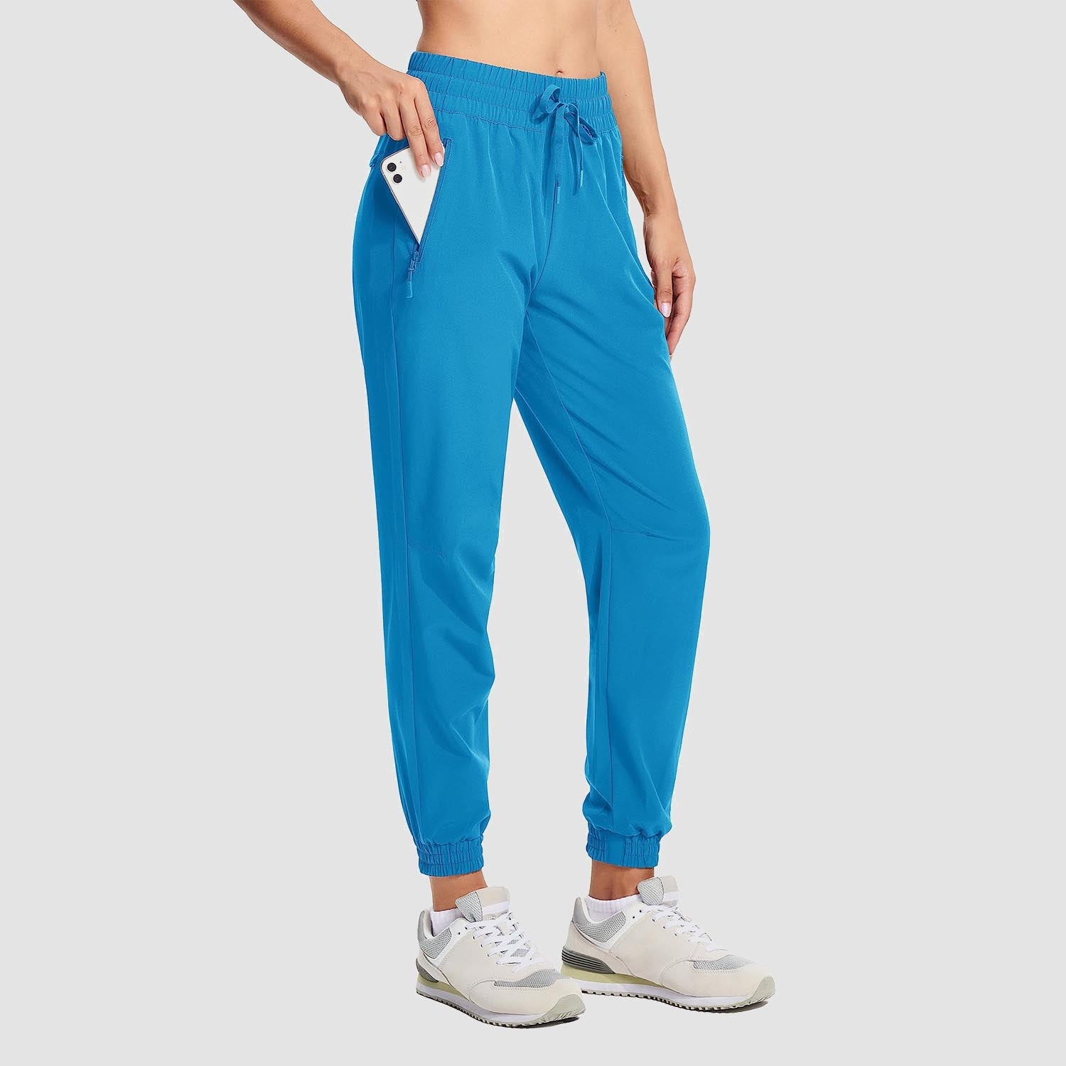 Women's lightweight gray hiking joggers with 4-way stretch, water-resistant fabric, and side pockets