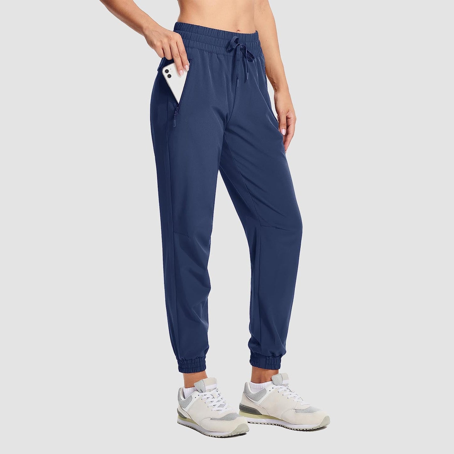 Women's lightweight gray hiking joggers with 4-way stretch, water-resistant fabric, and zippered pockets
