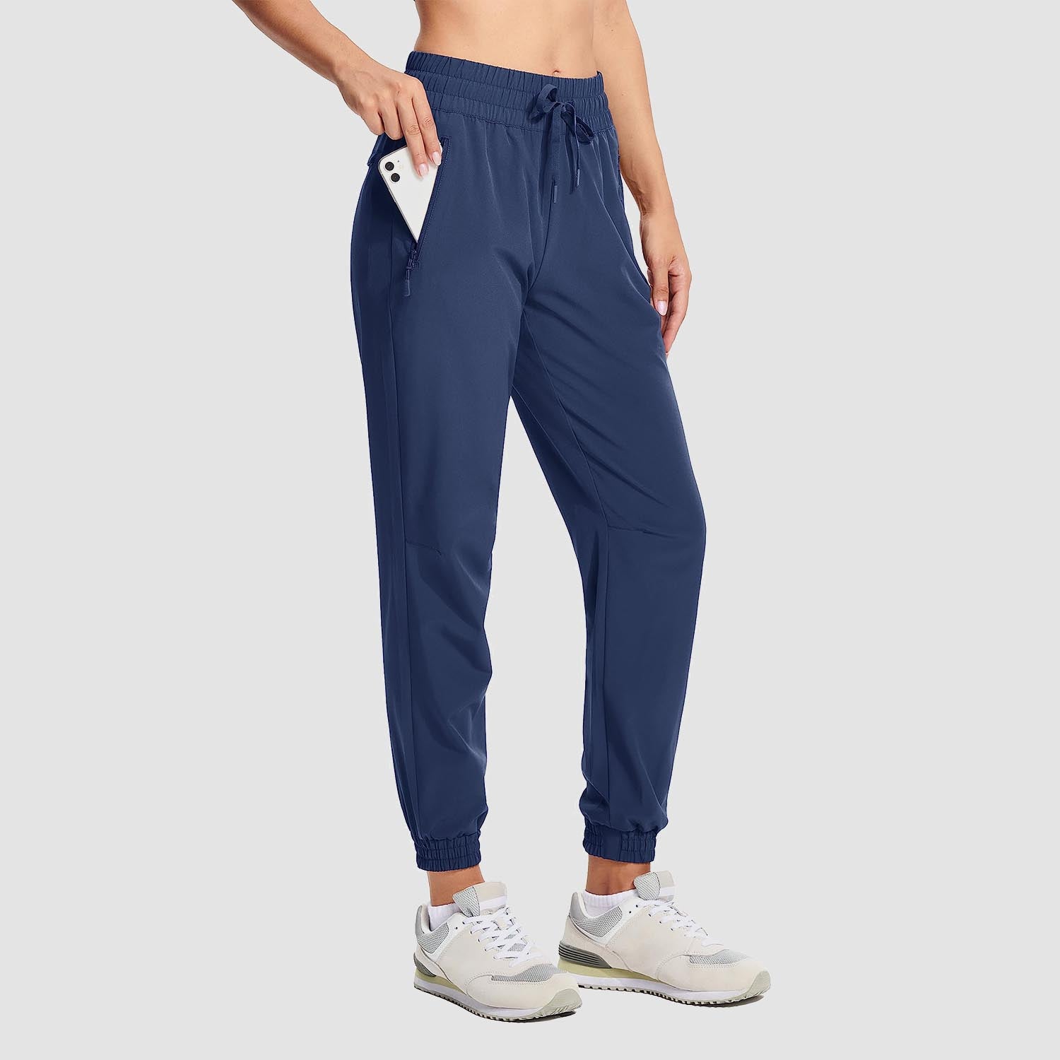 Women's lightweight gray hiking joggers with 4-way stretch, water-resistant fabric, and zippered pockets