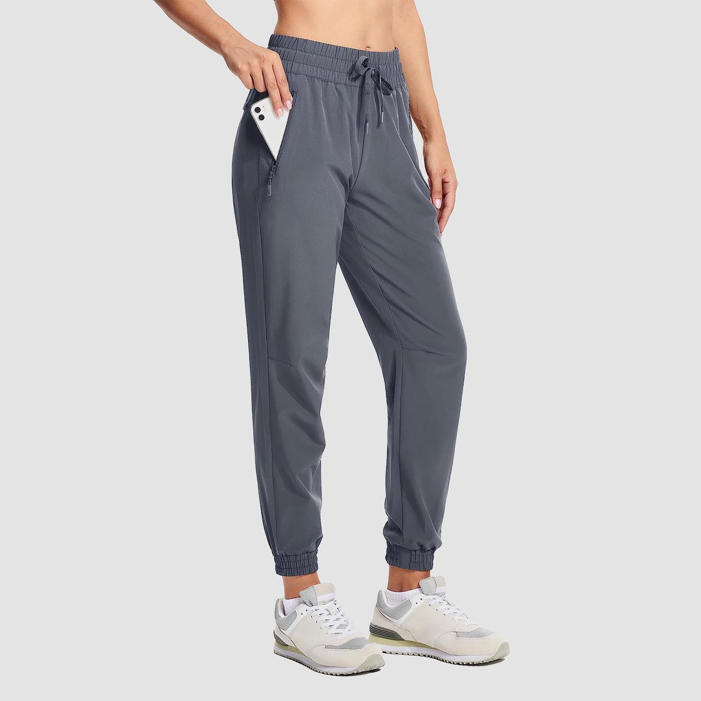 Women's lightweight gray hiking joggers with 4-way stretch, water-resistant fabric, and zippered pockets
