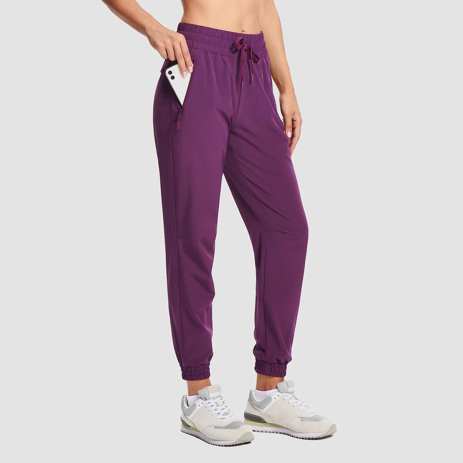 Women's lightweight gray hiking joggers with 4-way stretch, water-resistant fabric, and multiple pockets