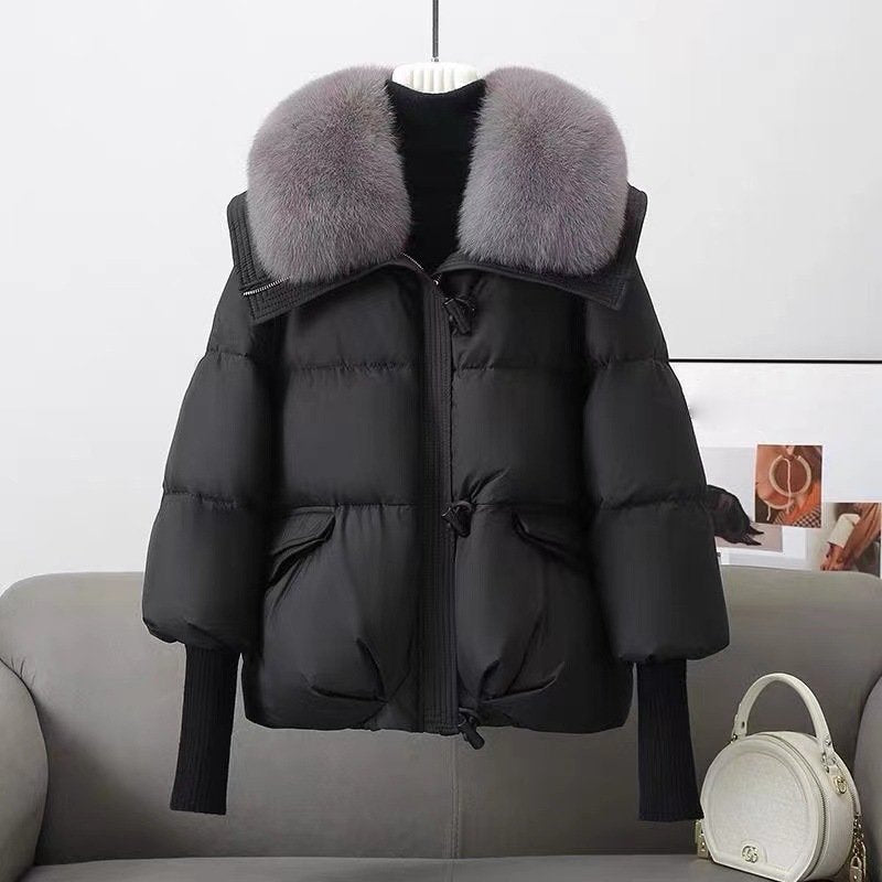 Women's oversized hip-length quilted jacket in neutral tone with luxurious faux fur collar for winter