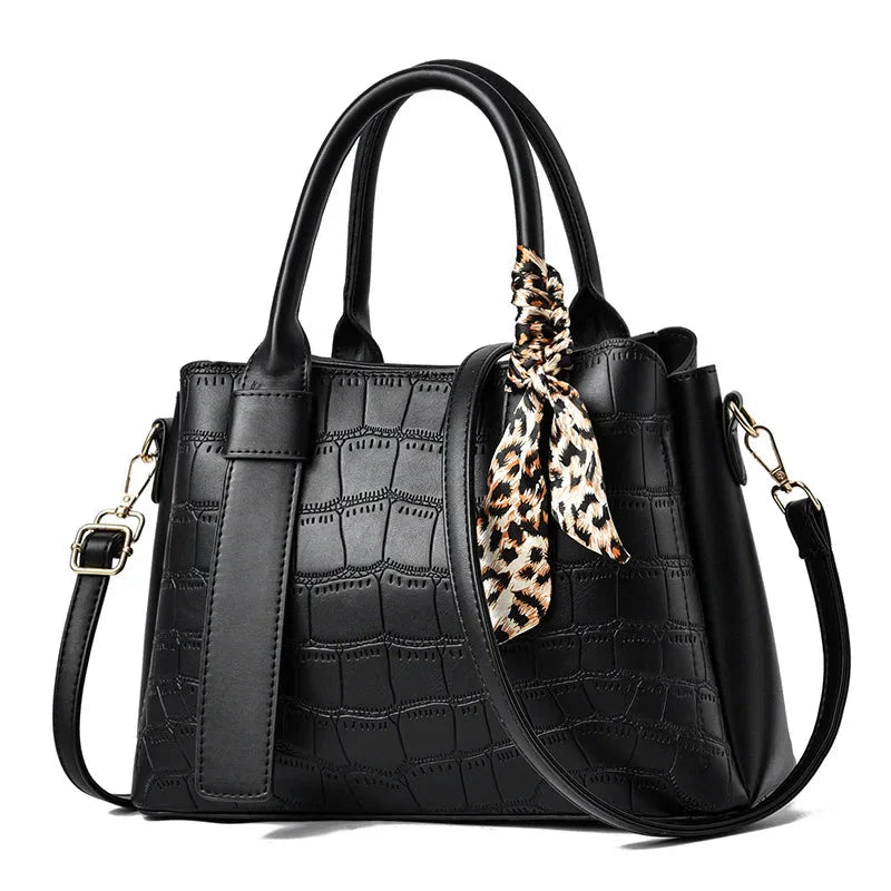 Structured women's black leather embossed tote bag with elegant texture and versatile top handle design