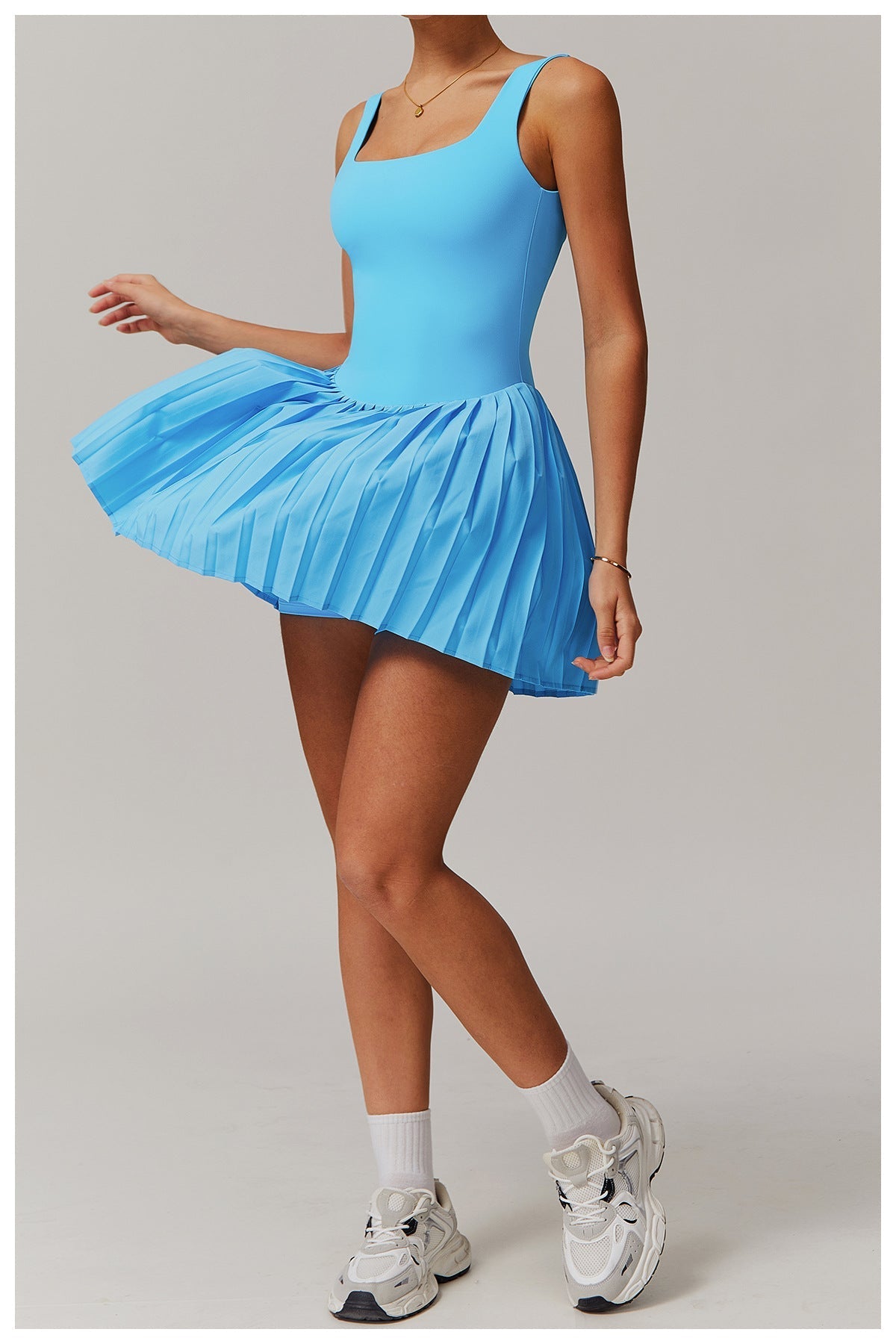 White sleeveless tennis tank dress with built-in support, moisture-wicking one-piece athletic fit