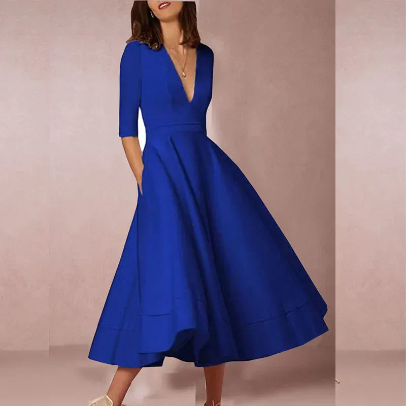 Elegant black A-line midi dress with deep V-neck, three-quarter sleeves, and textured luxurious fabric
