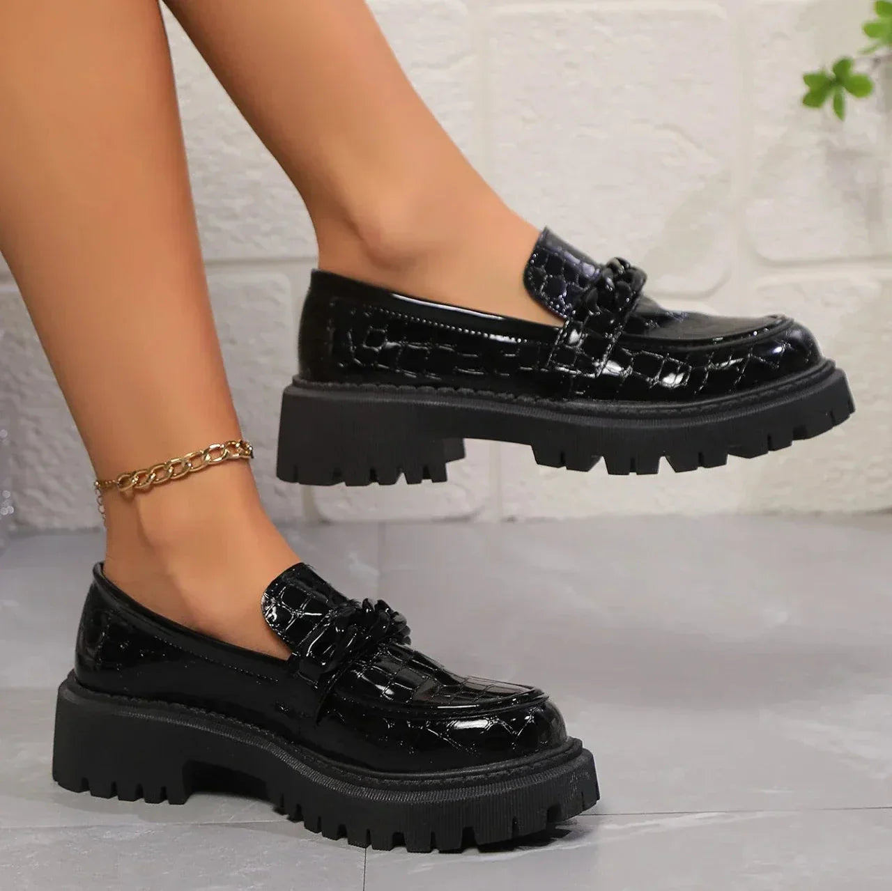 Black vegan leather platform loafers with crocodile embossing and satin-gloss finish for women