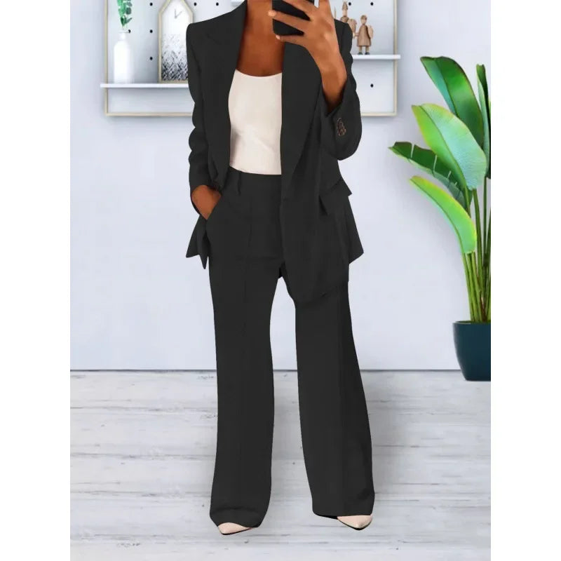 Women's black tailored long blazer suit set with straight-leg trousers and refined lapel