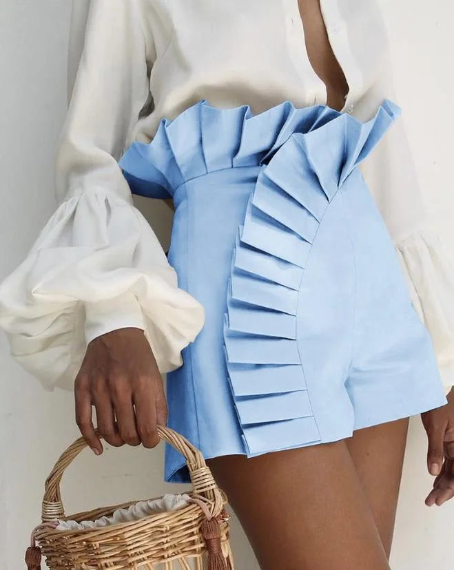 Women's ivory pleated high-waist shorts with cascading ruffles and flattering sculpted silhouette