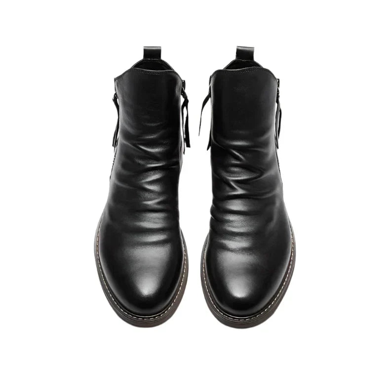 Handcrafted black leather Chelsea boots with zipper closure and sleek ankle silhouette