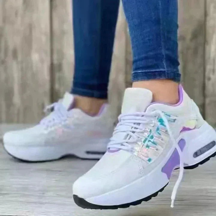 White ergonomic orthopedic running shoes with shock-absorbing soles for stable joint support