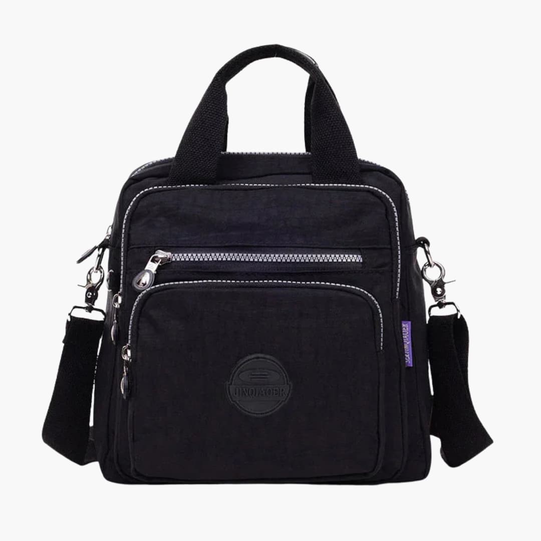 Women's minimalist shoulder bag with adjustable crossbody strap and multiple organized pockets for travel