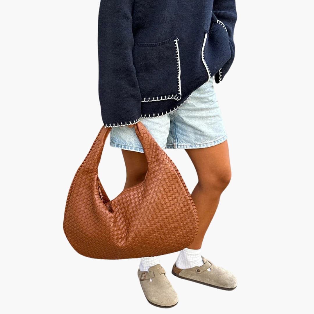 Women's braided woven shoulder bag with structured strap, zipper closure, and textured exterior