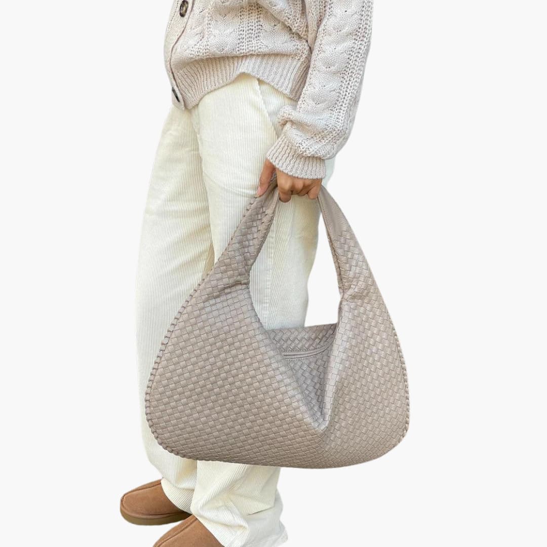 Women's braided woven shoulder bag with structured strap, secure zipper closure, textured exterior