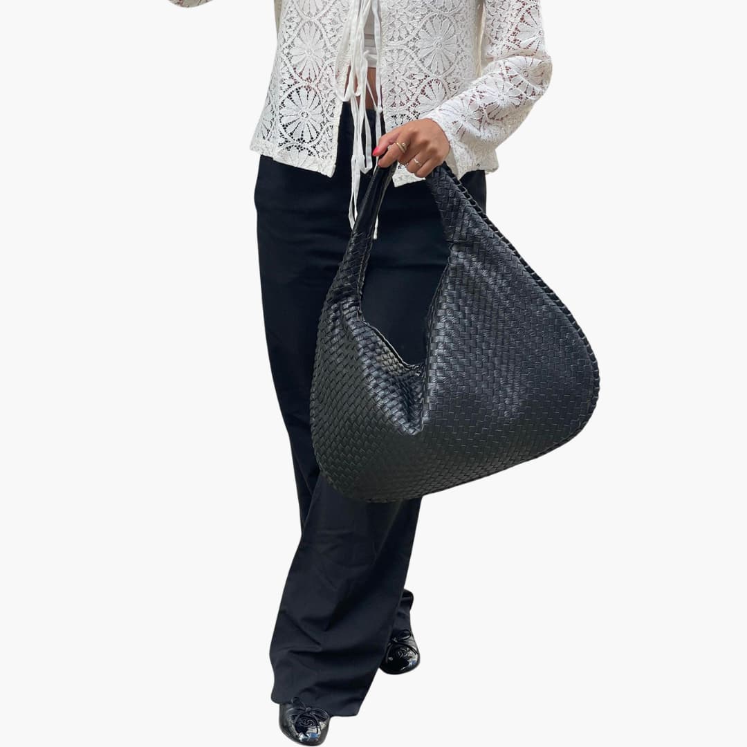 Women's braided woven shoulder bag with structured strap, textured exterior, and secure zipper closure