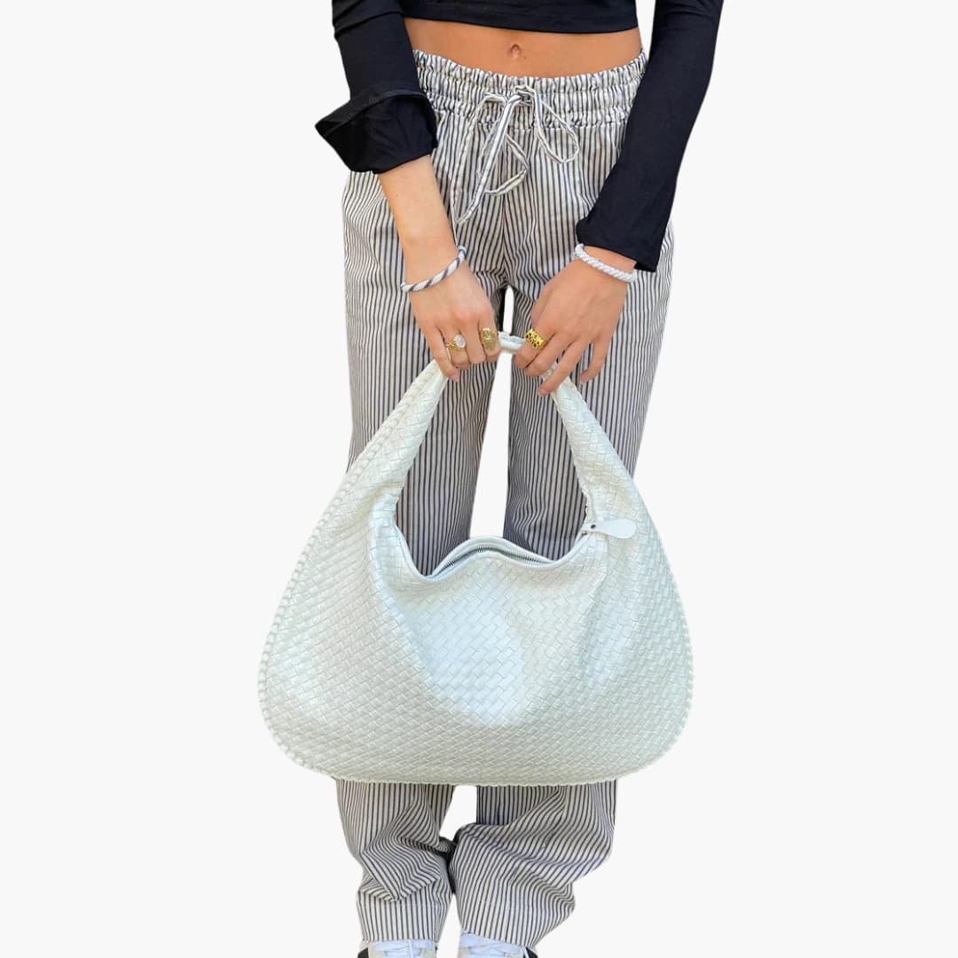 Women's braided woven shoulder bag with structured strap, textured exterior, and secure zipper closure