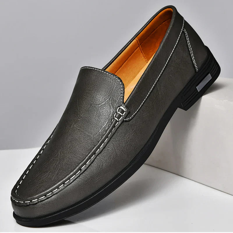 Men's brown embossed genuine leather slip-on loafers with textured finish and premium dress shoe silhouette