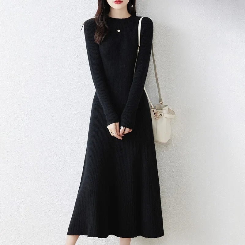 Women's black long-sleeve wool knit dress with subtle rib texture and minimalist silhouette