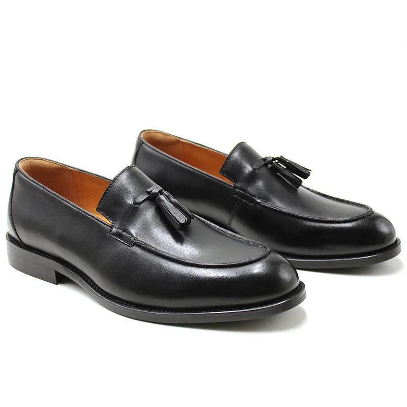Men's black genuine leather slip-on loafers with tassel detail, classic dress shoe silhouette