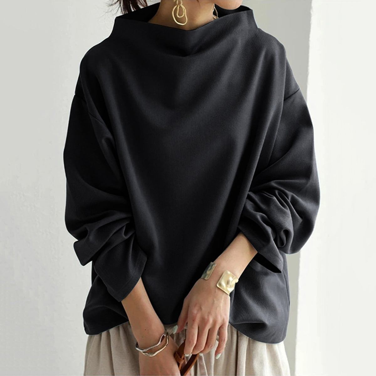 Black slim-fit knit pullover sweater with soft cotton-polyester blend, relaxed silhouette for women