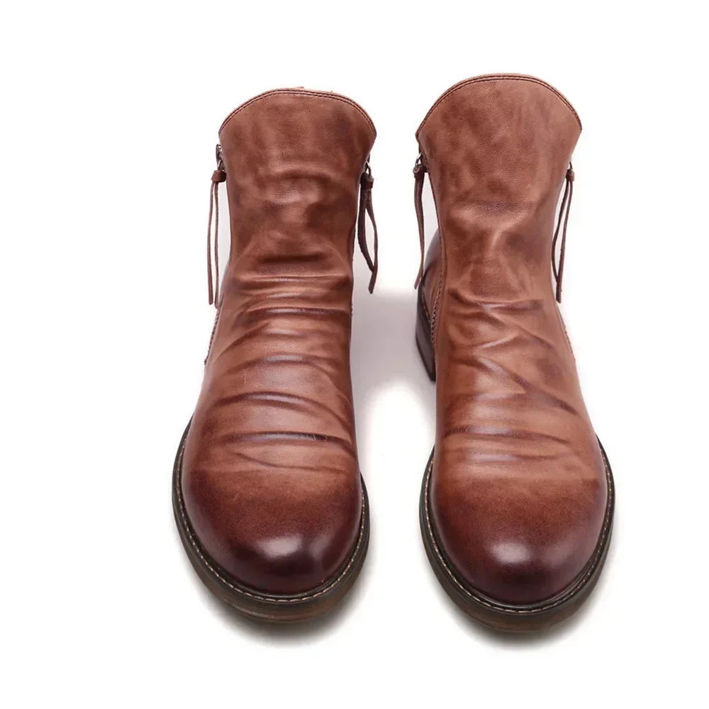 Handcrafted black leather Chelsea boots with zipper closure and sleek ankle-hugging silhouette
