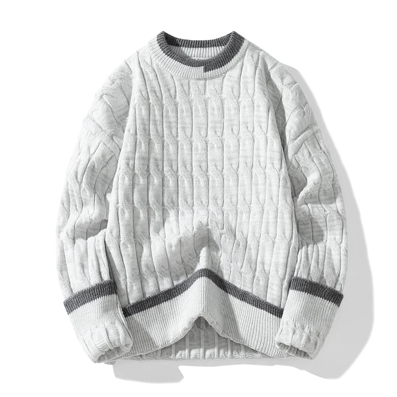 Unisex cable knit pullover sweater with cozy patchwork design in relaxed fit for cool-weather layers