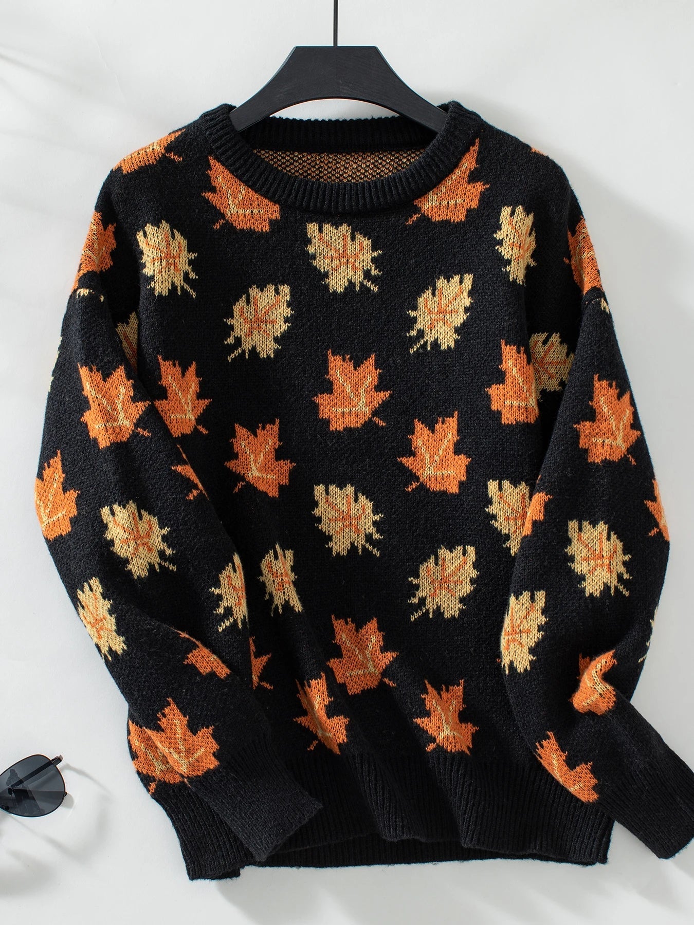 Women's cozy brown knitted pullover sweater with vibrant autumn leaves motif, relaxed warm fit