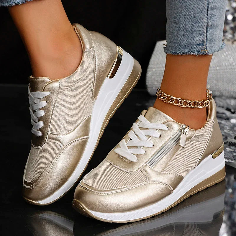 Women's white platform sneakers with metallic accents, lace-up closure, and cushioned sole